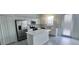 A bright, modern kitchen features stainless steel appliances, white cabinets, and a center island at 312 Nine Iron Dr, Davenport, FL 33896