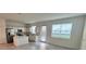 Bright kitchen features stainless steel appliances, white cabinets, center island, and grey tile flooring at 312 Nine Iron Dr, Davenport, FL 33896