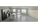 A bright, modern kitchen features stainless steel appliances, white cabinets, and a center island at 312 Nine Iron Dr, Davenport, FL 33896