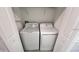 A laundry closet contains a white washer and dryer at 312 Nine Iron Dr, Davenport, FL 33896
