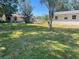 The backyard has a large grassy area perfect for children and pets to play at 3135 Old Dixie Hwy, Auburndale, FL 33823