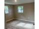 Cozy bedroom featuring light gray wood floors and two windows for plenty of light at 3135 Old Dixie Hwy, Auburndale, FL 33823
