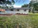 Well-maintained home featuring a brick accent, neutral paint and a covered porch at 3135 Old Dixie Hwy, Auburndale, FL 33823