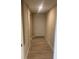 Inviting hallway with wood-style tile flooring leading to a white front door at 3135 Old Dixie Hwy, Auburndale, FL 33823