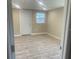 A bright living area offers wood-look floors and a freshly painted interior at 3135 Old Dixie Hwy, Auburndale, FL 33823