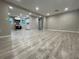 Open-concept living room flowing into the kitchen featuring modern light gray wood flooring at 3135 Old Dixie Hwy, Auburndale, FL 33823