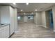 Spacious area showcases light gray wood flooring, connecting living spaces for seamless living at 3135 Old Dixie Hwy, Auburndale, FL 33823
