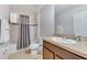 Bathroom with a shower-tub combo and a single sink vanity with a brown cabinet at 314 Annabelle Way, Davenport, FL 33837