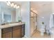Well-lit bathroom featuring a vanity with a speckled countertop and a glass-enclosed shower at 314 Annabelle Way, Davenport, FL 33837