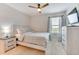 Inviting bedroom with a ceiling fan, a large window, and light wood furniture at 314 Annabelle Way, Davenport, FL 33837