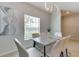 Bright dining area featuring modern lighting, comfortable seating, and a large window at 314 Annabelle Way, Davenport, FL 33837