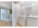 Neat laundry room with a washer, a dryer, and built-in shelving for storage at 314 Annabelle Way, Davenport, FL 33837