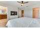 Spacious main bedroom with a ceiling fan, TV, walk-in closet and an en-suite bathroom at 314 Annabelle Way, Davenport, FL 33837