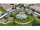 An aerial view of a community pool, surrounding residences, and parking at 3300 Whitestone Cir # 201, Kissimmee, FL 34741