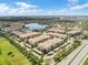 An aerial view showcasing residences, parking, lake, and pool in a community at 3300 Whitestone Cir # 201, Kissimmee, FL 34741
