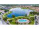An aerial view of a community featuring a pool, lake, walking path and residences at 3300 Whitestone Cir # 201, Kissimmee, FL 34741