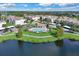 Aerial view of a pool, residences, and verdant landscaping in the community at 3300 Whitestone Cir # 201, Kissimmee, FL 34741