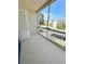 Screened-in balcony area with white railings and a view of the complex grounds at 3300 Whitestone Cir # 201, Kissimmee, FL 34741