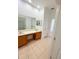 Bathroom featuring double sinks, tile floors, and a walk-in closet at 3300 Whitestone Cir # 201, Kissimmee, FL 34741