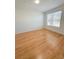 A light-filled bedroom offers wood-look floors and a large window at 3300 Whitestone Cir # 201, Kissimmee, FL 34741