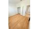 A bright bedroom features wood-look flooring and closet with bi-fold doors at 3300 Whitestone Cir # 201, Kissimmee, FL 34741