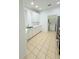 Bright kitchen features stainless steel appliances, and adjacent laundry area at 3300 Whitestone Cir # 201, Kissimmee, FL 34741