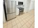 Kitchen featuring stainless steel appliances, white cabinets, and tile flooring at 3300 Whitestone Cir # 201, Kissimmee, FL 34741