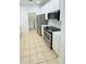 Kitchen with stainless steel appliances, and white cabinets, that connects to the laundry room at 3300 Whitestone Cir # 201, Kissimmee, FL 34741