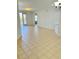 Open living space with neutral tile floors, access to the balcony, and white walls at 3300 Whitestone Cir # 201, Kissimmee, FL 34741