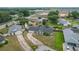 Aerial view of a charming single-Gathering home featuring mature landscaping, a long driveway, and a welcoming facade at 340 Vail Dr, Winter Haven, FL 33884