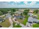 This aerial view shows the home's well-manicured lawn, long driveway, and landscaping at 340 Vail Dr, Winter Haven, FL 33884