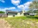 Exterior view of a single-story home featuring a well maintained grassy backyard at 340 Vail Dr, Winter Haven, FL 33884