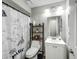 Bathroom featuring a shower with a Paris themed curtain, white vanity and toilet, and neutral paint at 340 Vail Dr, Winter Haven, FL 33884