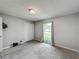 Neutral bedroom featuring grey carpet and walls, a window with curtains, and closet for storage at 340 Vail Dr, Winter Haven, FL 33884