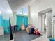 Bonus room features a large window with teal curtains, a black rubber floor, and neutral colored walls at 340 Vail Dr, Winter Haven, FL 33884