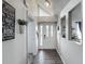 Bright entryway with gray plank flooring, a white front door, and views into the home at 340 Vail Dr, Winter Haven, FL 33884