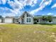 Charming single-story home with large windows, a gable roof and a well-manicured front lawn at 340 Vail Dr, Winter Haven, FL 33884