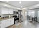 Bright kitchen featuring stainless steel appliances, white cabinets, and a cozy breakfast nook with backyard views at 340 Vail Dr, Winter Haven, FL 33884