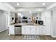 Bright kitchen with stainless steel appliances, granite counters, white cabinetry, and an open view to the living area at 340 Vail Dr, Winter Haven, FL 33884