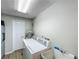 Laundry room features a white washer and dryer, water heater, white door and neutral paint at 340 Vail Dr, Winter Haven, FL 33884