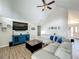Open living room with vaulted ceilings, plank floors, and modern decor at 340 Vail Dr, Winter Haven, FL 33884