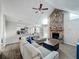Spacious living room showcasing a stone fireplace and views into the kitchen and dining area at 340 Vail Dr, Winter Haven, FL 33884