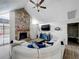 Inviting living room features a stone fireplace, plank flooring, and a vaulted ceiling at 340 Vail Dr, Winter Haven, FL 33884