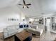 Open living room floorplan with views to the kitchen and dining areas and plank flooring at 340 Vail Dr, Winter Haven, FL 33884