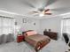Neutral toned main bedroom features a ceiling fan, grey walls and carpet, and a large dresser at 340 Vail Dr, Winter Haven, FL 33884