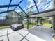 Enjoy this screened-in porch with outdoor seating, perfect for entertaining or relaxing at 340 Vail Dr, Winter Haven, FL 33884