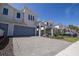 Inviting townhome featuring a paved driveway leading to a spacious two-car garage at 3470 Beau Rd, Kissimmee, FL 34746