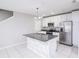 Modern kitchen boasts stainless steel appliances, granite countertops, and a stylish island at 3470 Beau Rd, Kissimmee, FL 34746