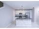 Bright kitchen features an island, white cabinets, stainless steel appliances, and modern lighting at 3470 Beau Rd, Kissimmee, FL 34746