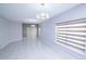 Open living area features modern lighting, gray tile flooring, and large windows with white blinds at 3470 Beau Rd, Kissimmee, FL 34746